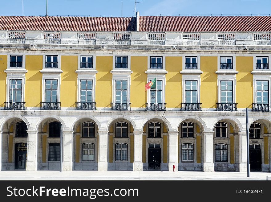 Yellow facade of the building at Lisbon's Terreiro do PaÃ§o