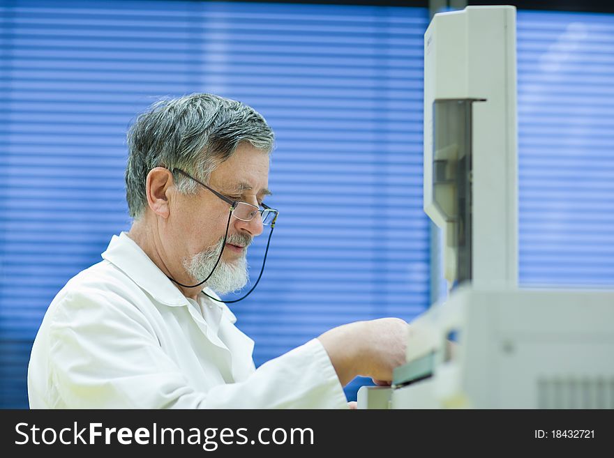Senior male researcher carrying out scientific research in a lab (shallow DOF; color toned image). Senior male researcher carrying out scientific research in a lab (shallow DOF; color toned image)