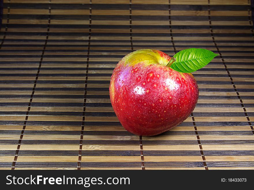 Fresh crunchy red apple on bamboo mat. Fresh crunchy red apple on bamboo mat.