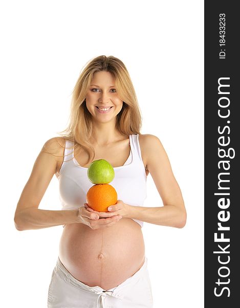 Pregnant woman with apples and oranges isolated on white