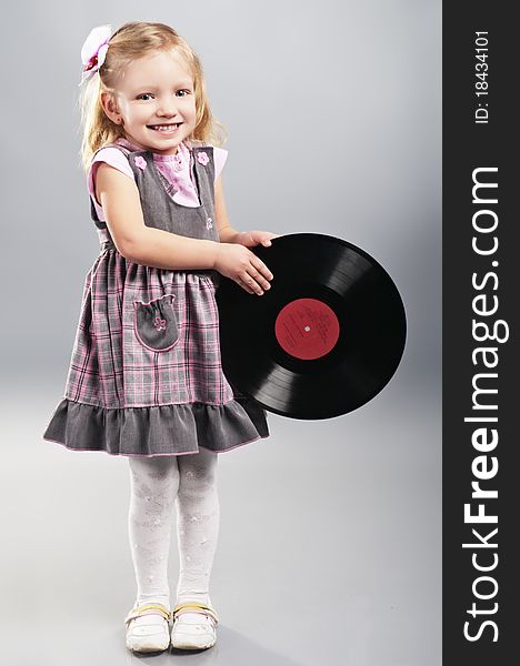 The little girl holds vinyl record