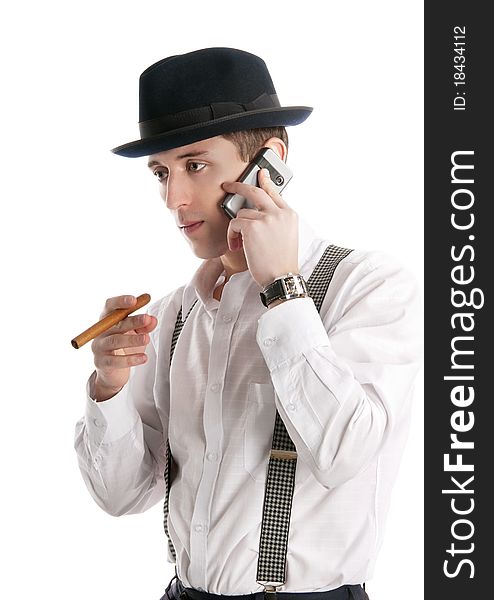 Young man talks by a mobile phone and holds cigar. Isolated on white background
