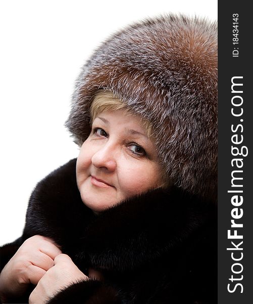 Beautiful woman wearing in fur hat and in fur coat on a white background