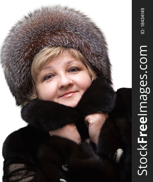 Beautiful woman wearing in fur hat and in fur coat on a white background