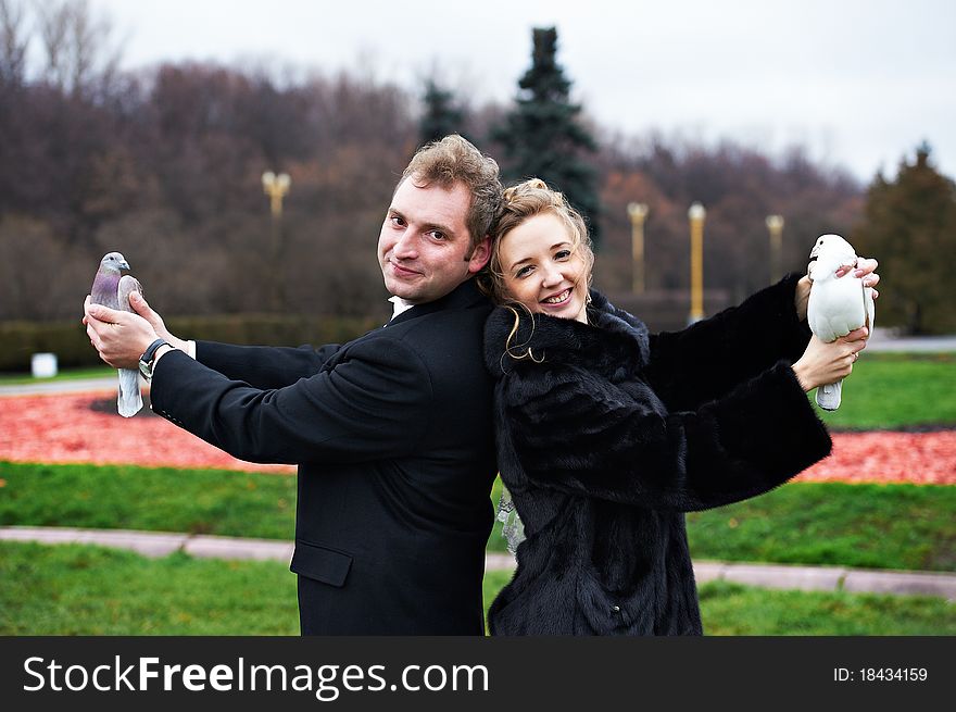 Bride and groom with pigeons on hands