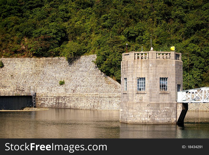 It is the landscape of a reservoir with a tower. It is the landscape of a reservoir with a tower.