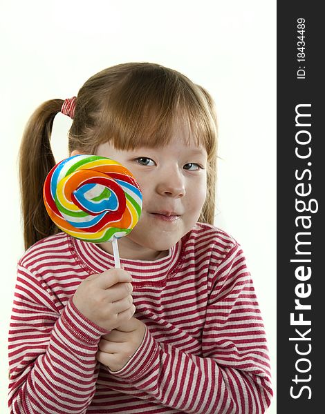 Portreit of a little girl eating a lollipop