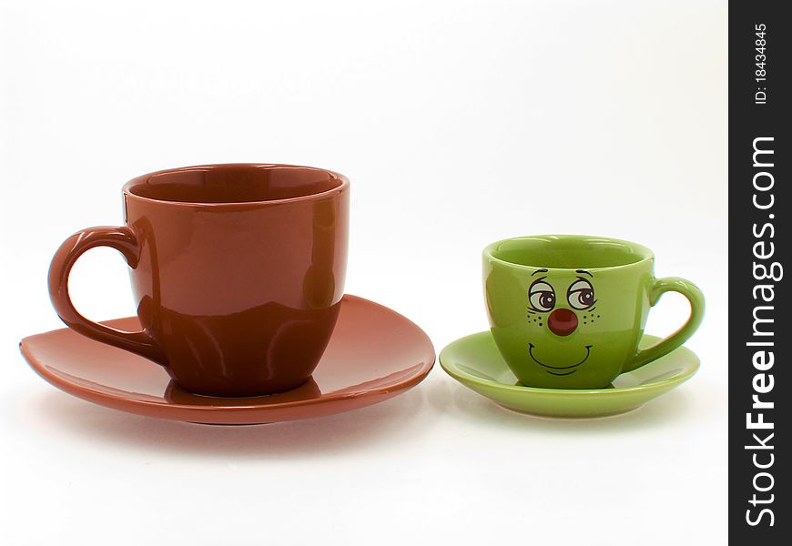 A Brown Cup Beside a Green Kid's Cup