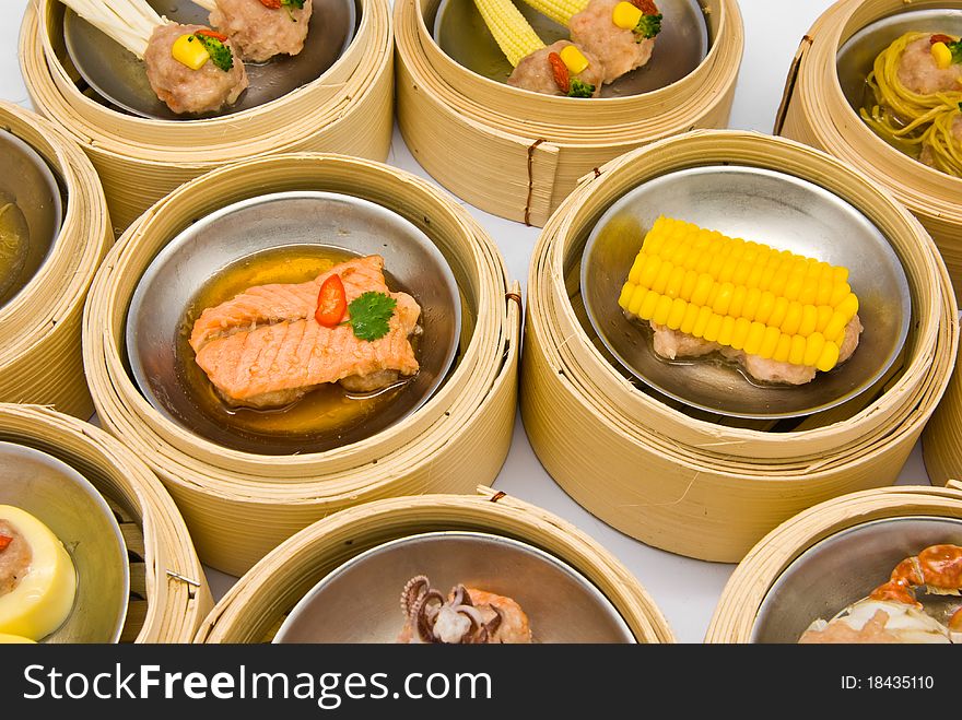 Chinese steamed dimsum in bamboo containers traditional cuisine. Chinese steamed dimsum in bamboo containers traditional cuisine