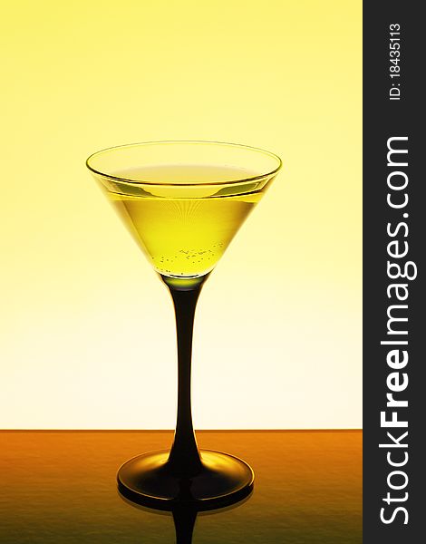 Wine in a glass on a yellow background. Wine in a glass on a yellow background