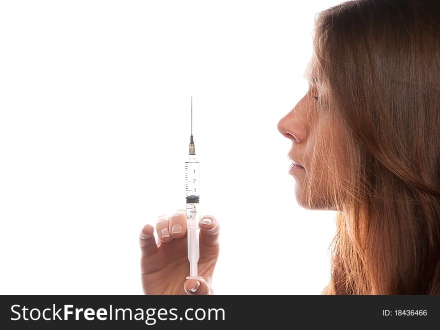 Young female doctor holding a syringe isolated on a white background
