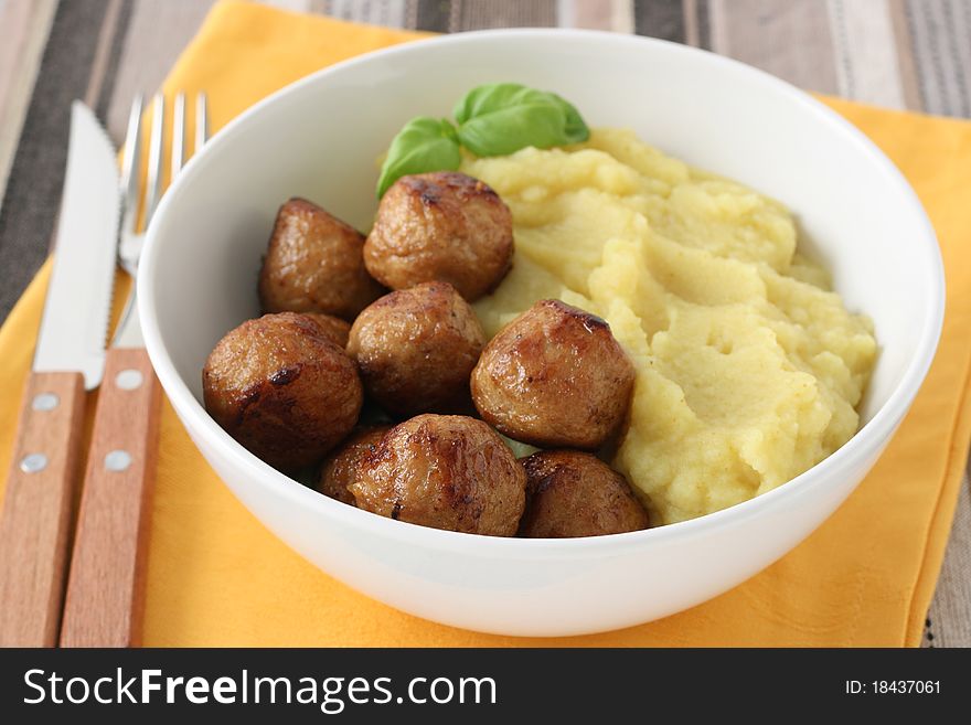 Chicken meatballs with mashed potato in a bowl