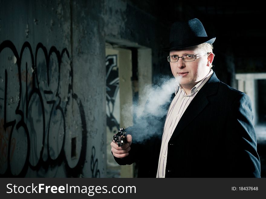 Young detective smoking and aiming with gun. Young detective smoking and aiming with gun.