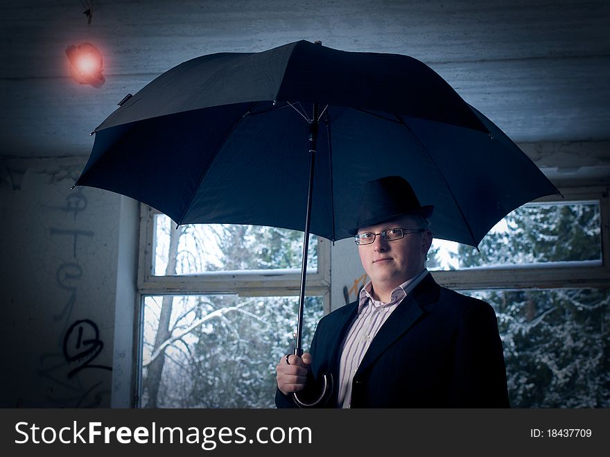 Man with umbrella in old building. Conceptual idea finding