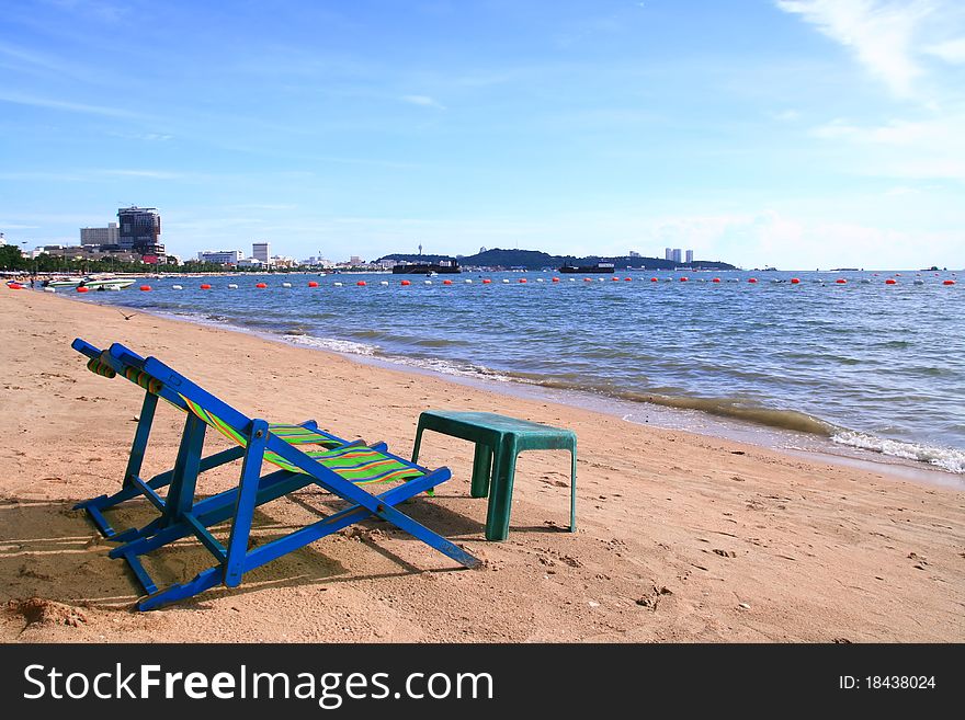 Couples of beach chairs and table on the beach in Pattaya City