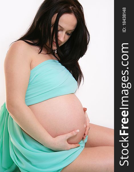 Portrait of beautiful young pregnant woman in fabric
