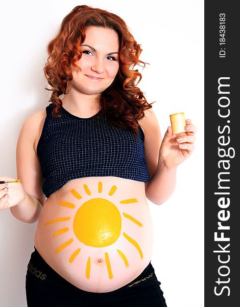 Conceptual image of happy pregnant female with painted pictures on her belly