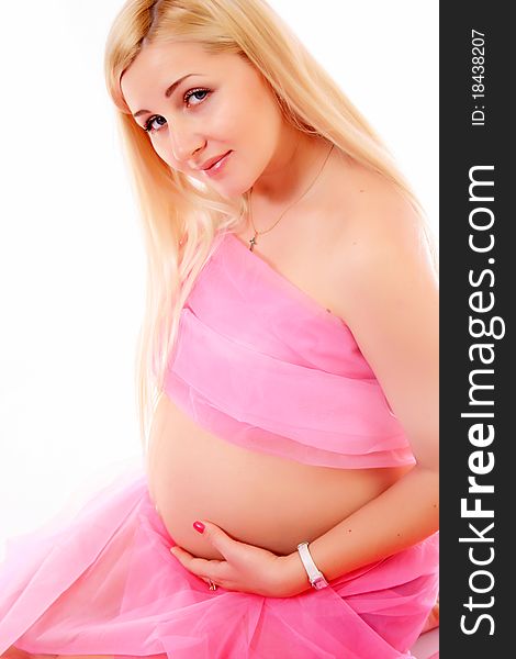 Young pregnant blond woman holding her belly