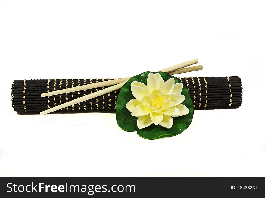 Water lily flower with bamboo rug and Chinese chopsticks
