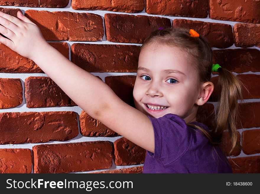 Beautiful smiling girl leaning against the break wall. Beautiful smiling girl leaning against the break wall