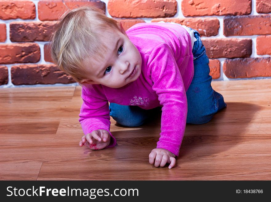 Beautiful baby crawling on the wooden floor. Beautiful baby crawling on the wooden floor