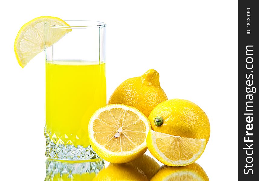 Fresh lemon and fresh lemon juice in a glass