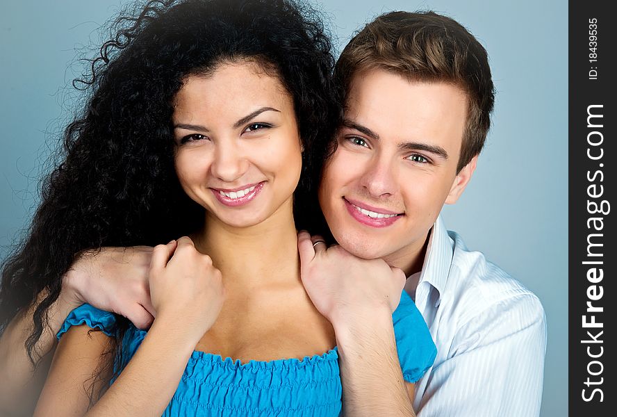 Smiling couple isolated on a greybackground