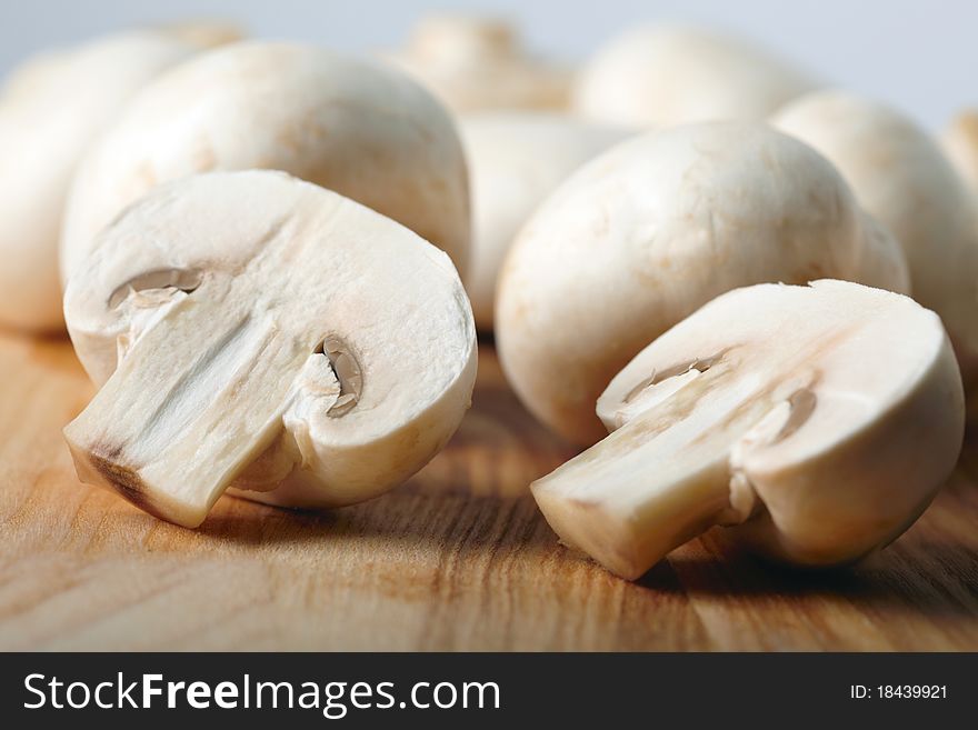 Champignons on wooden board background
