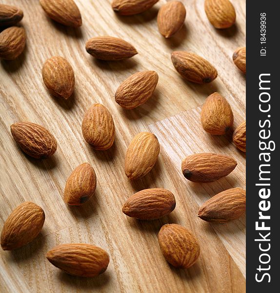 Almonds on wooden board background