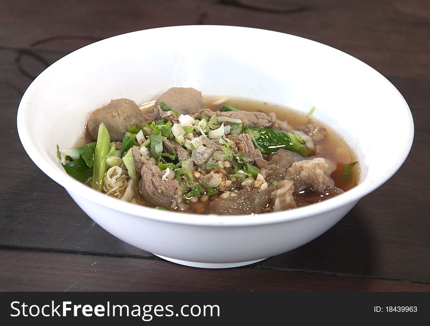 Traditional Thai Beef noodle on the wooden desk