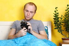 Man Lying In Bed And Winding Up Alarm Clock Stock Images