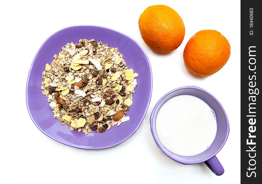 Muesli, milk and oranges isolated on white. Muesli, milk and oranges isolated on white