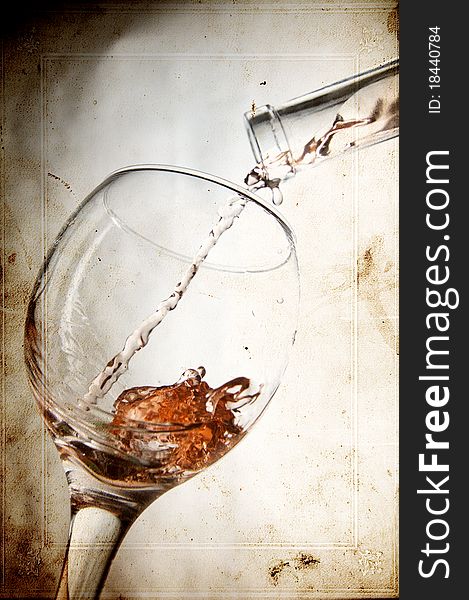 Pouring red vine in glass on vintage background