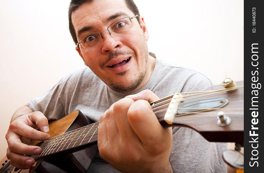 Funny man with glasses playing guitar. Funny man with glasses playing guitar