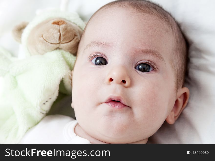 Closeup portrait of adorable baby with toy