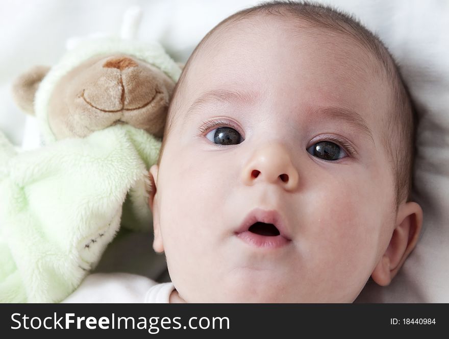 Closeup portrait of adorable baby with toy