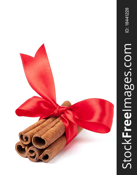Cinnamon sticks with ribbon isolated on white background