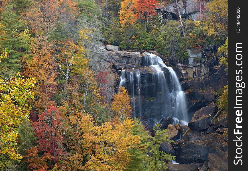 Beautiful white water falls in the rustic autumn mountains of Western North Carolina. the highest falls east of the Rockies. Beautiful white water falls in the rustic autumn mountains of Western North Carolina. the highest falls east of the Rockies.