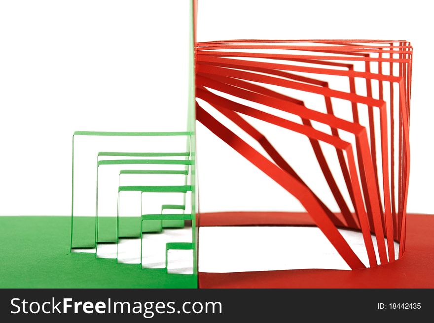 Abstract green and red paper composition with cutout stripes and folds, side view, isolated