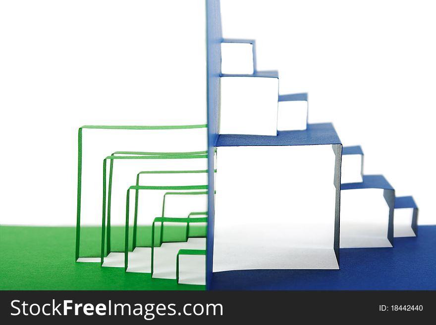 Abstract green and blue paper composition with cutout stripes and folds, side view, isolated