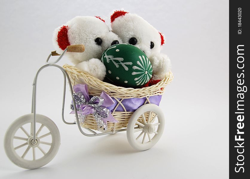 Two white teddy bears with an Easter egg. Two white teddy bears with an Easter egg