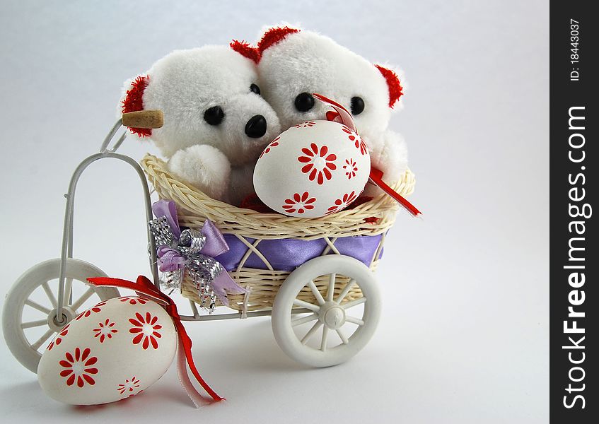 Two white teddy bears with an Easter eggs. Two white teddy bears with an Easter eggs