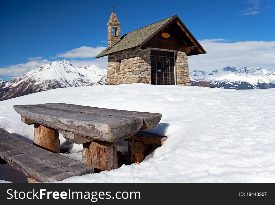 A small chapel in the mountains during winter. Mortirolo Pass, Lombardy region, Italy