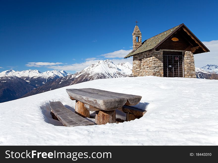 A small chapel in the mountains during winter. Mortirolo Pass, Lombardy region, Italy