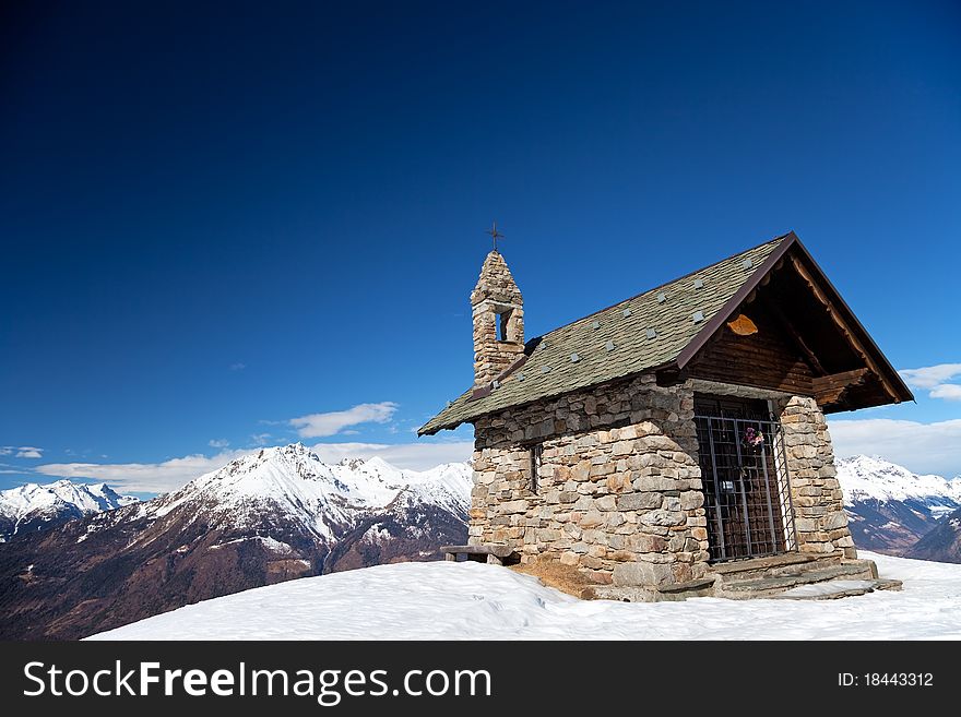 A small chapel in the mountains during winter. Mortirolo Pass, Lombardy region, Italy