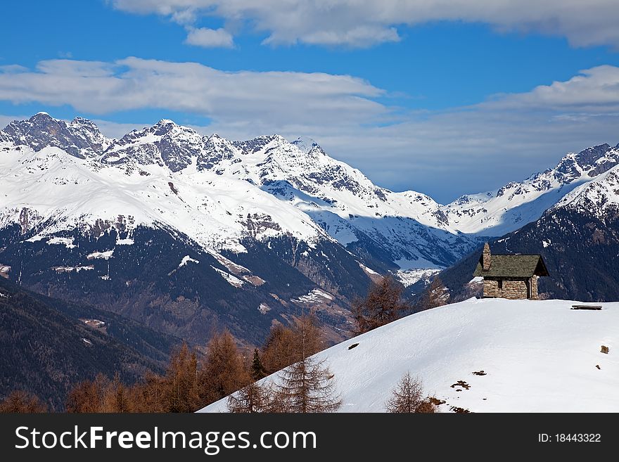 A small chapel in the mountains during winter. Mortirolo Pass, Lombardy region, Italy