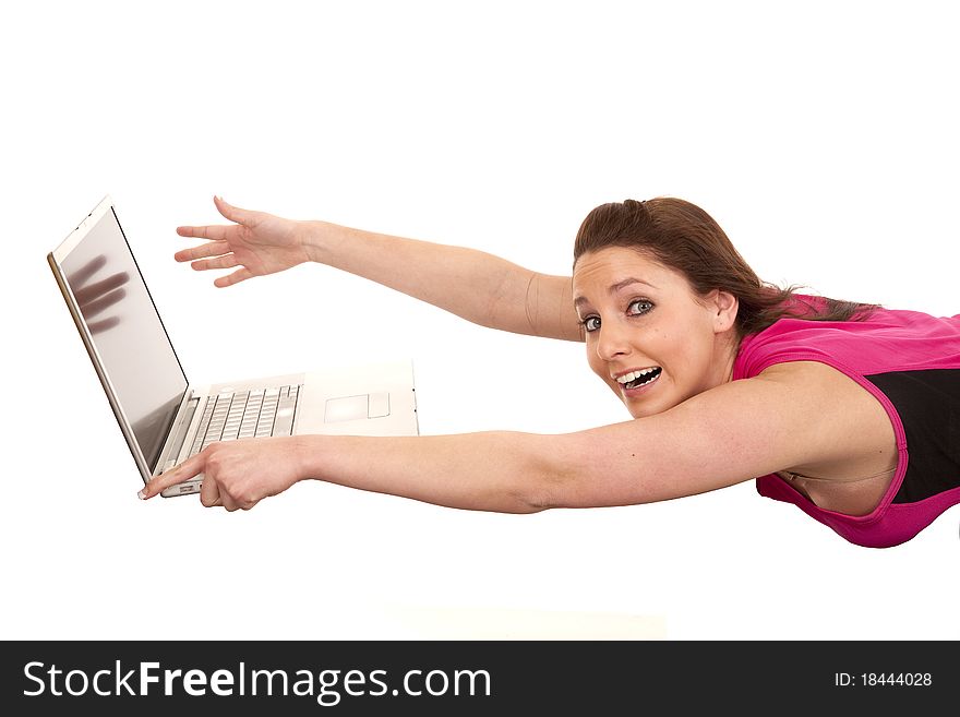 A woman is blowing away from a laptop computer. A woman is blowing away from a laptop computer.