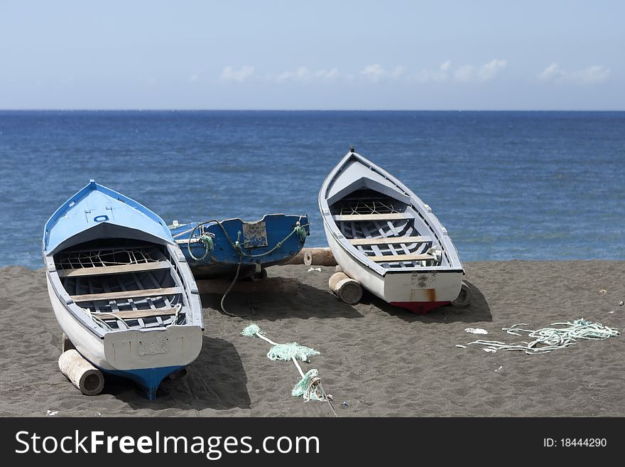 Fishing boats on the beach in the sun