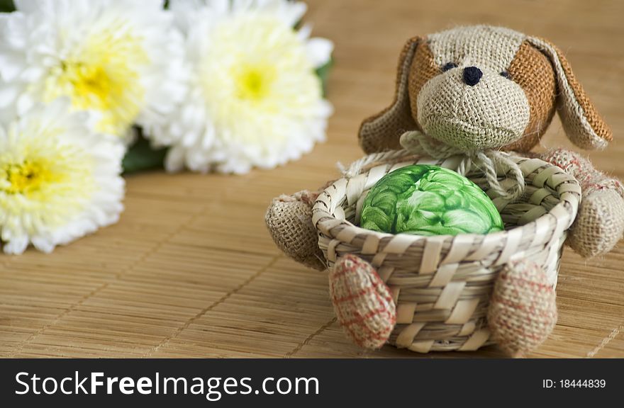 Easter colored eggs in a wicker vase of chrysanthemums. Easter colored eggs in a wicker vase of chrysanthemums