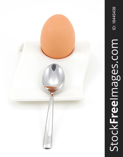 Soft boiled egg in egg holder with spoon